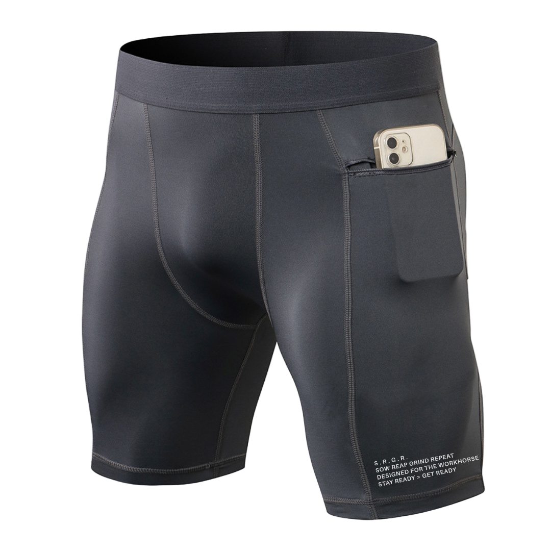 Dark gray athletic shorts with a pocket holding a phone on a white background
