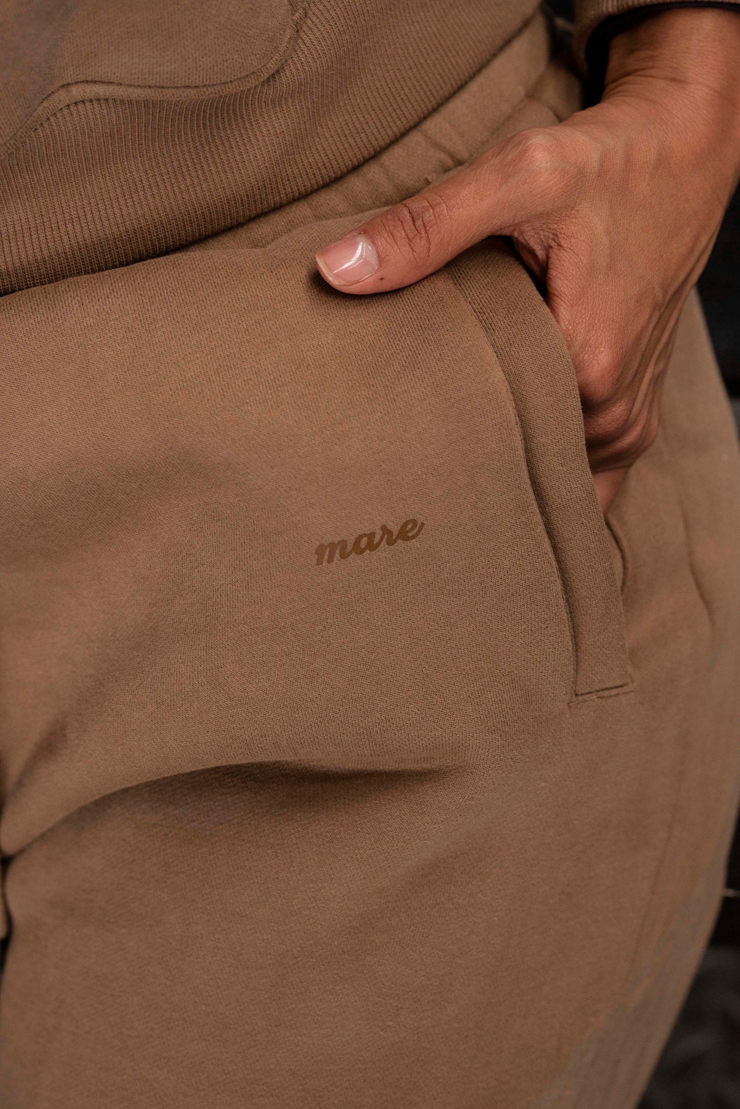 Close-up of the brown mare jogger with logo.