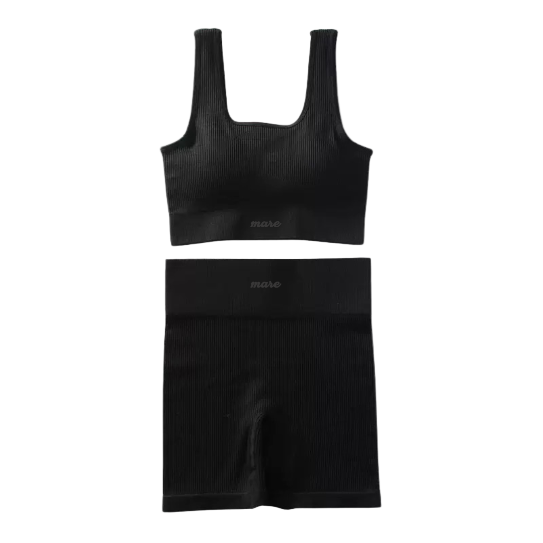 Black ribbed tank top and shorts set on a white background