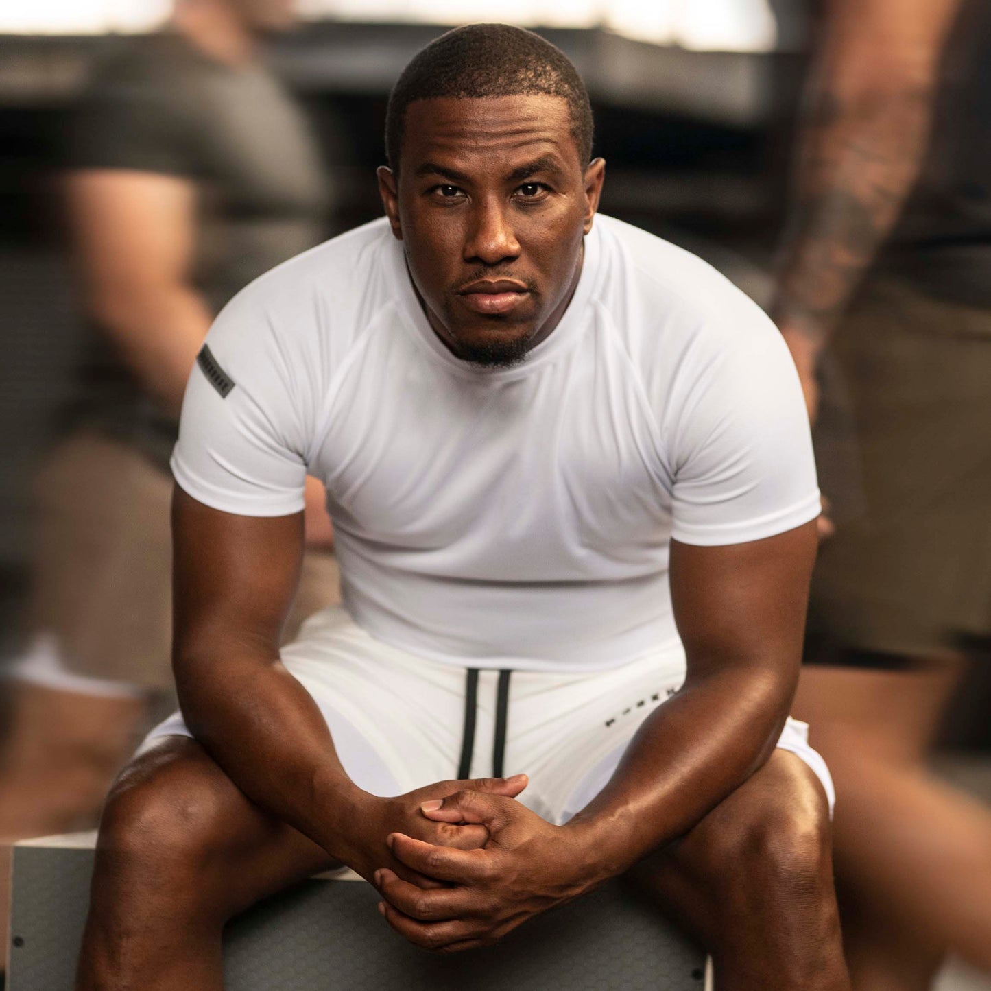 Model wearing Workhorse's White Sport Performance T-Shirt with 'Workhorse' patch on the right sleeve.