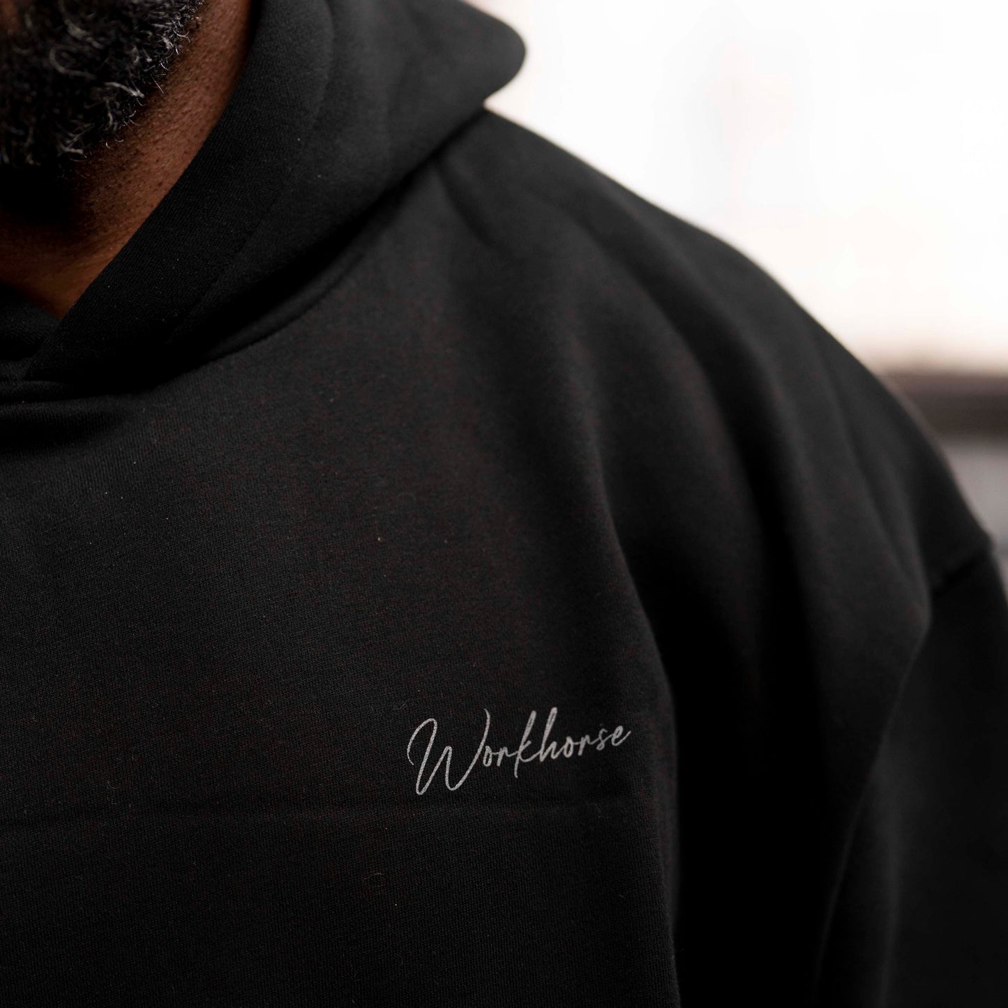 Model wearing Workhorse Oversize Hoodie in color black.