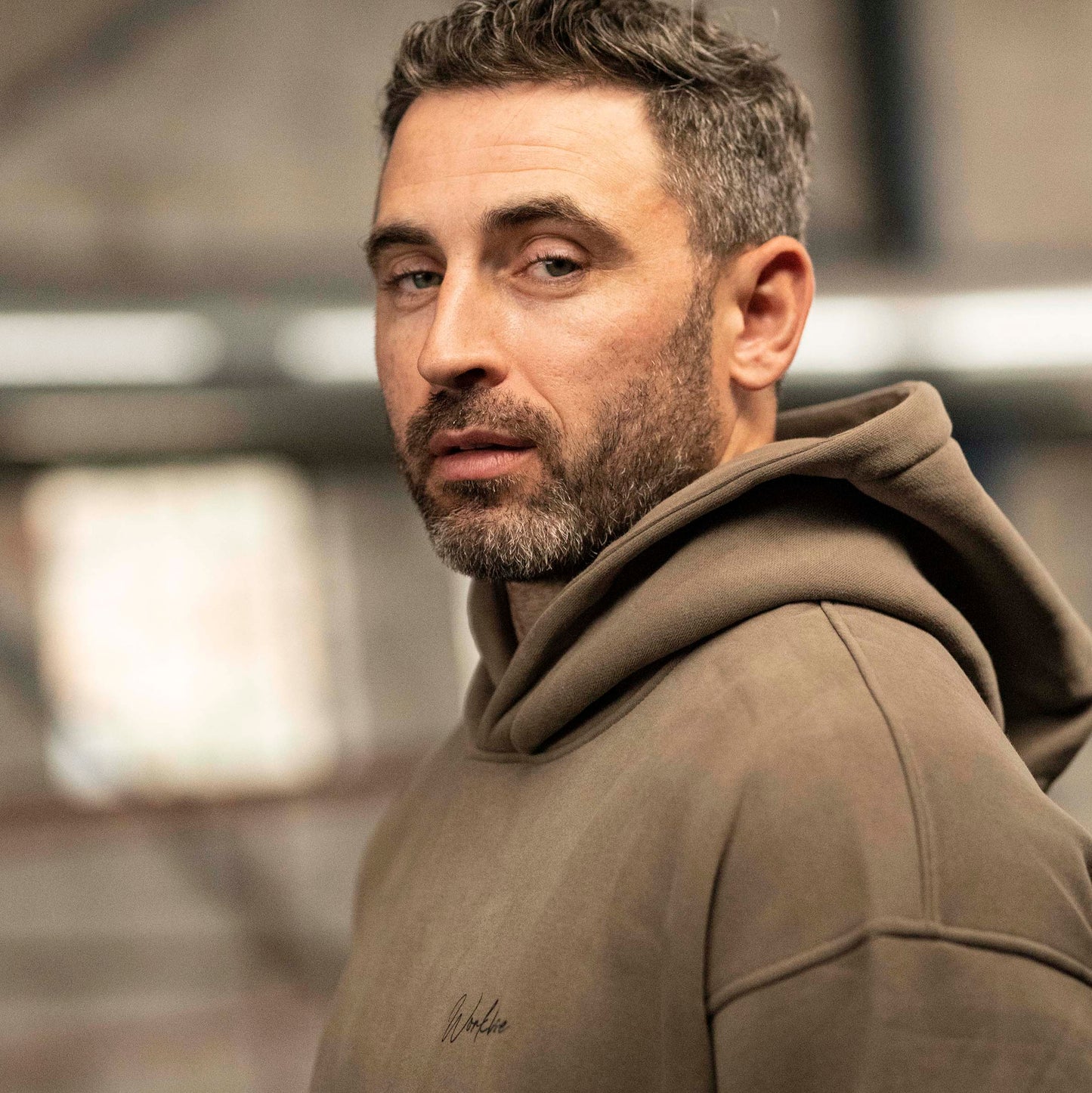 Model wearing Workhorse Oversize Hoodie in color brown.