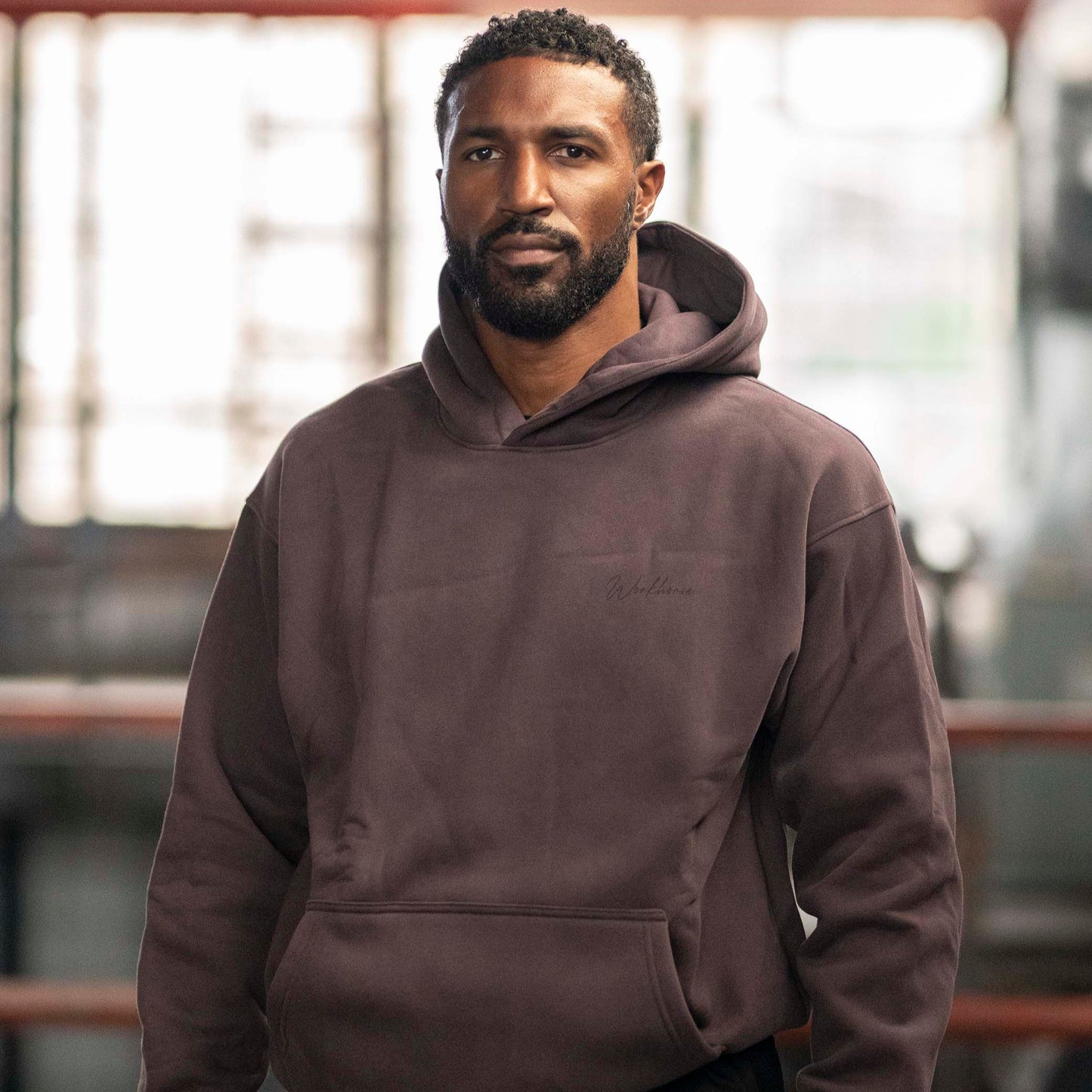 Model Workhorse Oversize Hoodie in color plum in an indoor setting.