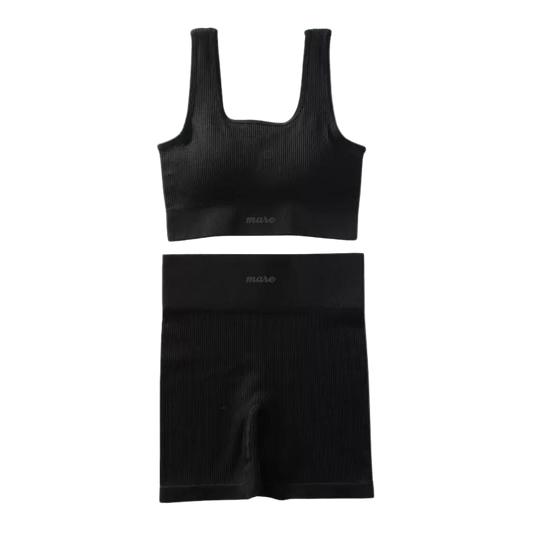 Black ribbed tank top and shorts set on a white background